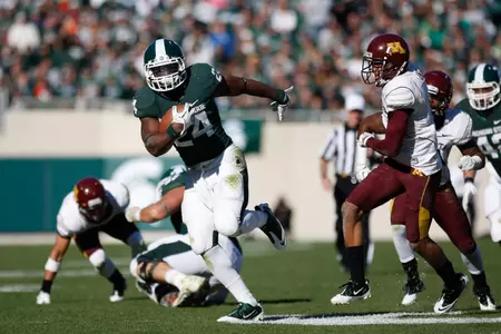 LeVeon Bell breaks free from the Minnesota defense on his way to a 35-yard touchdown run. Matthew Mitchell/MSU Athletic Communications