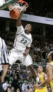 Branden Dawson dunks against UMKC's Estan Tyler, right, and Reggie Chamberlain. Dawson scored a career-high 16 points.