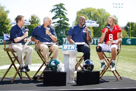 Howard Griffith and Kirk Cousins share a laugh on the Big Ten Network set after Friday's practice.