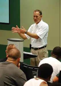 Mark Dantonio conducts a team meeting Saturday in the Skandalaris Football Center.