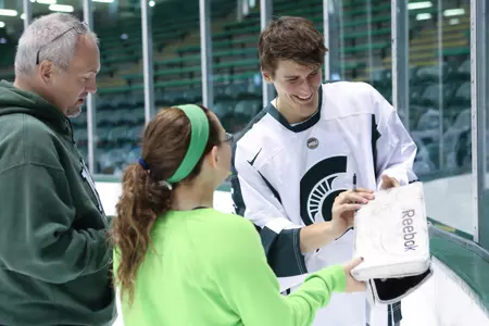 Will Yanakeff signs a blocker at the Meet the Spartans event at Munn earlier this month