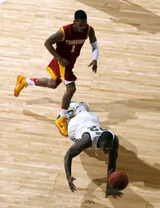 Branden Dawson, bottom, dives for the loose ball in front of Tuskegee's Javier McKinney (1) during the first half. (AP Photo/Al Goldis)