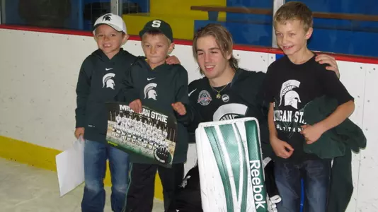 Jake Hildebrand poses with a young fan in Cheboygan earlier this season
