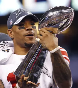 New York Giants wide receiver Devin Thomas admires the Vince Lombardi Trophy after the Giants' 21-17 win over the New England Patriots in the NFL Super Bowl XLVI football game, Sunday, Feb. 5, 2012, in Indianapolis. (AP Photo/Paul Sancya)
