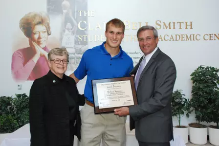 Kirk Cousins poses for a photo with MSU Faculty Athletics Representative Michael Kasavana following Monday's special recognition by the National Football Foundation and Fidelity Investments.
