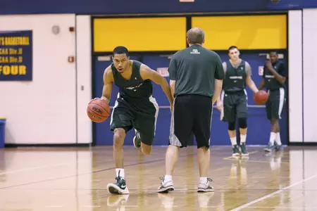 Brandan Kearney dribbles around a manager during Tuesday's practice at Phoenix College.