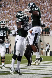 Michigan State's Le'Veon Bell (24) and Bennie Fowler (13) celebrate Bell's first-quarter touchdown against Boise State.