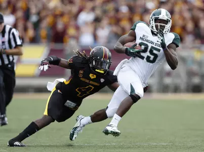 Keith Mumphrey runs the ball, pursued by Central Michigan safety Jahleel Addae.