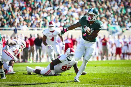 Jeremy Langford rushed for three touchdowns, including a 32-yarder in the third quarter, and also caught an 11-yard TD pass from Connor Cook against Indiana.