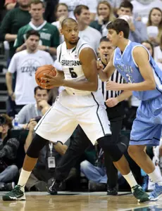 Center Adreian Payne (5) posts up against Lions forward Alex Rosenberg (13).