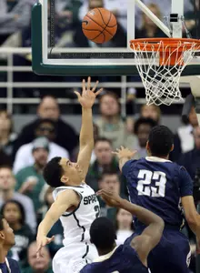 Travis Trice (20) drives to the basket. (Mike Carter-USA TODAY Sports)