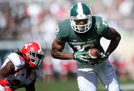 Wide receiver Bennie Fowler runs the ball after a catch in the first half.