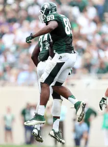Defensive end Shilique Calhoun (89) and linebacker Taiwan Jones (34) celebrate fumble recovery for a touchdown against the Bulls during the first half. Mandatory Credit: Mike Carter-USA TODAY Sports