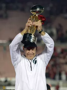 MSU head coach Mark Dantonio holds up the 100th Rose Bowl Game trophy following MSU's 24-20 victory over No. 5 Stanford.