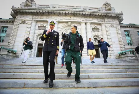 Travis Trice walks the steps of Bancroft Hall with Capt. Bill Byrne, Commandant of the US Naval Academy.