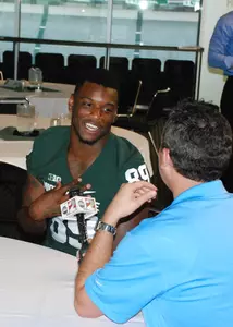 Shilique Calhoun speaks to a reporter at media day inside the Huntington Club at Spartan Stadium.