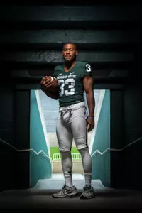 Senior running back Jeremy Langford poses during a photo shoot on media day at Spartan Stadium.