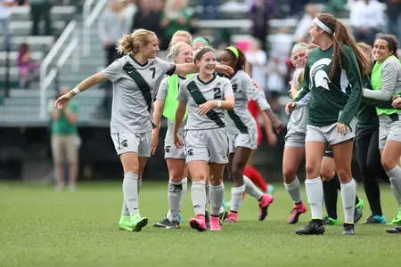 Captain Mary Kathryn Fiebernitz hugs teammate Allyson Krause after beating New Mexico.