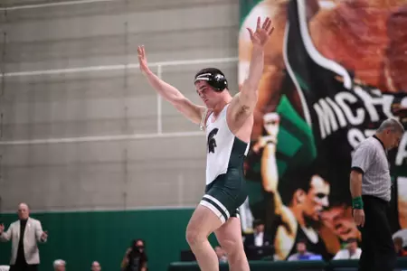 Nick McDiarmid walks off the platform at Jenison Field House for the final time of his career following a 3-1 victory over CMU's Jackson Lewis on Senior Night.