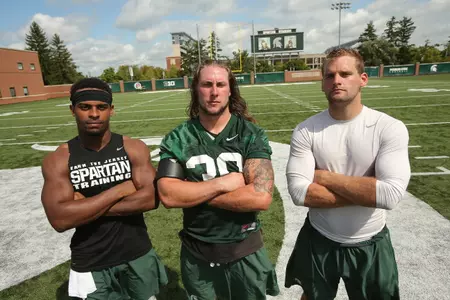 <B><i>The 2016 team captains pose for a photo following Thursday's practice: safety Demetrious Cox, linebacker Riley Bullough and quarterback Tyler O'Connor.</b></i>