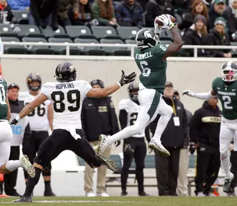 Michigan State's David Dowell (6) interceps a pass intended for Purdue's Brycen Hopkins (89) during the first quarter of an NCAA college football game, Saturday, Oct. 27, 2018, in East Lansing, Mich. (AP Photo/Al Goldis)