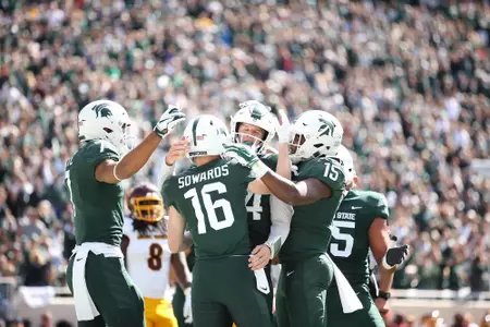 Brian Lewerke, Brandon Sowards, La'Darius Jefferson, Cody White, team celebration vs CMU