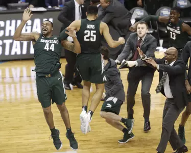 Michigan State forward Nick Ward (44) and Kenny Goins (25) celebrate with teammates after beating Duke at the end of the NCAA men's East Regional final collage basketball game in Washington, Sunday, March 31, 2019. Michigan State won 68-67. (AP Photo/Mark Tenally