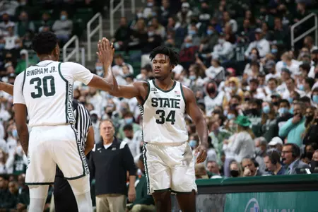 Julius Marble high-fives Marcus Bingham during Michigan State's win over Louisville on Wed. Dec. 1 at the Breslin Center in East Lansing, Mich.