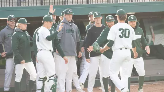 Team dugout celebration vs Michigan