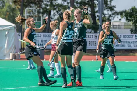 Meredith Ross, Ashley Harlock and Nienke Bloemsaat celebrate vs. Central Michigan on Sept. 19, 2021