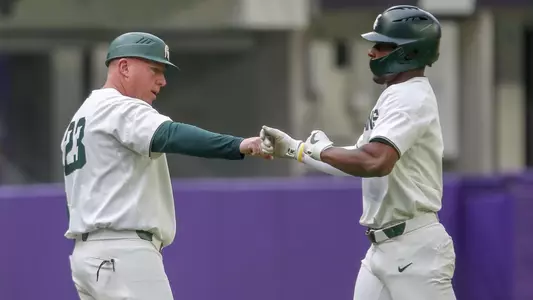 Coach Boss, Zaid Walker fist bump vs Kansas 2022