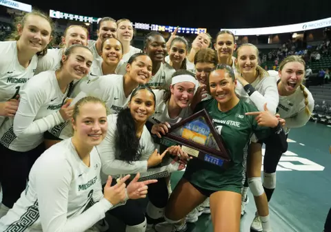 Volleyball celebrates with state pride flag, 2023, home michigan