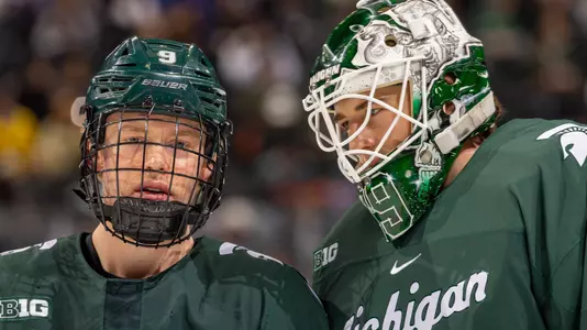 DETROIT, MI - FEBRUARY 11: Pierce Charleson #29 talks to teammate Matt Basgall #9 of the Michigan State Spartans in warm ups before an NCAA MenÕs college hockey Dual in the D game against the Michigan Wolverines at Little Caesars Arena on February 11, 2023 in Detroit, Michigan. The Wolverines defeated the Spartans 4-3 in O.T. (Photo by Dave Reginek/Getty Images) *** Local Caption *** Pierce Charleson; Matt Basgall