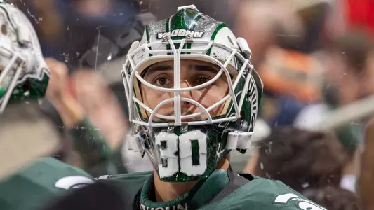 DETROIT, MI - FEBRUARY 11: Jon Mor #30 of the Michigan State Spartans watches the action from the bench against the Michigan Wolverines during the first period of an NCAA MenÕs college hockey Dual in the D game at Little Caesars Arena on February 11, 2023 in Detroit, Michigan. The Wolverines defeated the Spartans 4-3 in O.T. (Photo by Dave Reginek/Getty Images) *** Local Caption *** Jon Mor