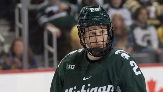 DETROIT, MI - FEBRUARY 11: Daniel Russell #20 of the Michigan State Spartans looks down the ice against the Michigan Wolverines during the first period of an NCAA MenÕs college hockey Dual in the D game at Little Caesars Arena on February 11, 2023 in Detroit, Michigan. The Wolverines defeated the Spartans 4-3 in O.T. (Photo by Dave Reginek/Getty Images) *** Local Caption *** Daniel Russell