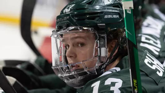 DETROIT, MI - FEBRUARY 11: Tiernan Shoudy #13 of the Michigan State Spartans watches the action from the bench against the Michigan Wolverines during the first period of an NCAA MenÕs college hockey Dual in the D game at Little Caesars Arena on February 11, 2023 in Detroit, Michigan. The Wolverines defeated the Spartans 4-3 in O.T. (Photo by Dave Reginek/Getty Images) *** Local Caption *** Tiernan Shoudy