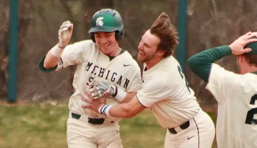 Ryan McKay and Dillon Kark and team celebrate McKay's walk-off single vs Rutgers