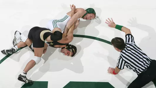Spartan Nick Simmons, center, holds Boilermaker Brandon Tucker, left, as referee _________ counts off the fourth second for a near takedown Friday (2/3/06) at Jenison Fieldhouse in East Lansing, MI. Simmons won the 125 pound match 8-4, remaining undefeated at 23-0 on the season. Michigan State won 22-11 over Purdue.