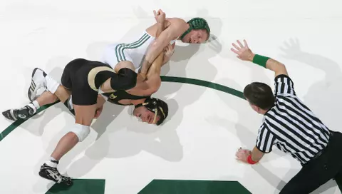 Spartan Nick Simmons, center, holds Boilermaker Brandon Tucker, left, as referee _________ counts off the fourth second for a near takedown Friday (2/3/06) at Jenison Fieldhouse in East Lansing, MI. Simmons won the 125 pound match 8-4, remaining undefeated at 23-0 on the season. Michigan State won 22-11 over Purdue.