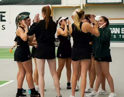 2024-25 women's tennis team high fives vs Ball State