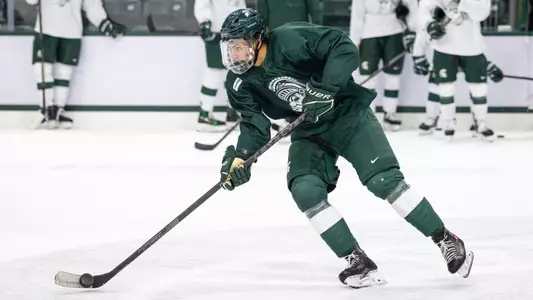 Chase Reid handles the puck during Michigan State hockey practice