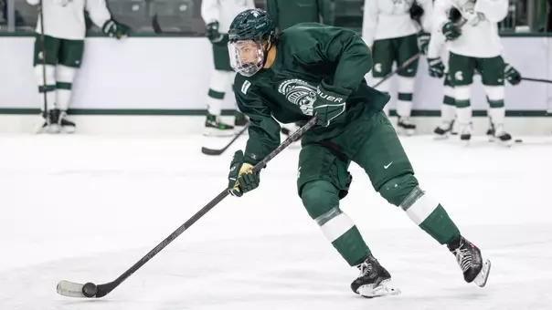 Chase Reid handles the puck during Michigan State hockey practice