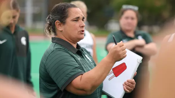 Tamara Durante speaks to the team on the sidelines
