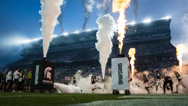 Michigan State runs out of the tunnel in the season opener vs. Toledo.