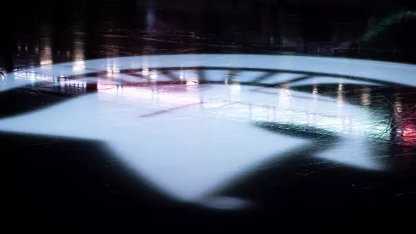 Spartan logo projected on the Munn ice