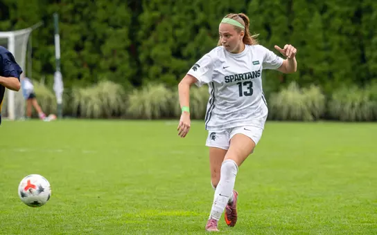 LJ Pearcy moves the ball forward in a rainy game vs. Michigan
