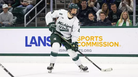 Brady Peddle handles the puck against Northern Michigan at Munn Ice Arena