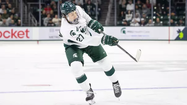 Chase Reid shoots the puck against Boston College
