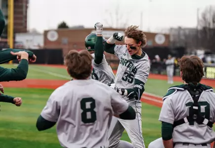 Randy Seymour and team celebrate at dugout