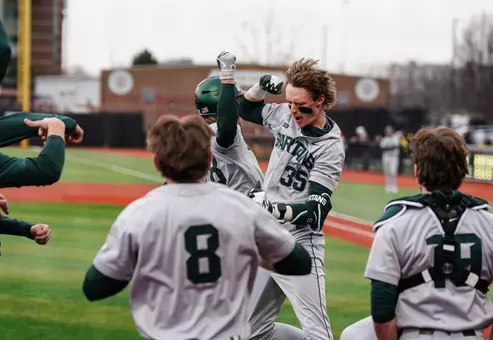 Randy Seymour and team celebrate at dugout